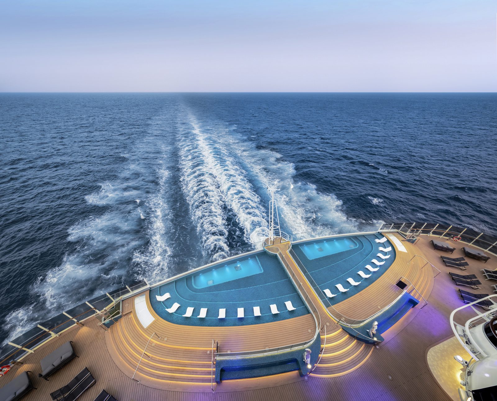 The aft Infinity Pool on MSC Seascape overlooking the ship's wake at dusk